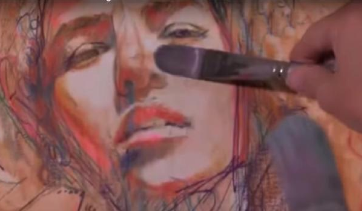 Women portrait wiht brush hovering infront of canvas orange and flesh tones